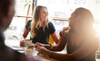 © peopleimages.com - Laughing, friends or women in coffee shop for support, funny conversation or gossip news together. Happy, talking or people speaking of drinking espresso or tea in discussion or chat in cafe diner
