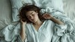 © Helen-HD - A woman with long hair is peacefully sleeping on a comfortable bed, with a pillow and blanket. Her eyelashes flutter as she dreams, emanating beauty and grace