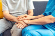Female doctor nurse holding hand of senior man patient having disease health problem - Empathy, support, rehabilitation, comfort and therapist concept