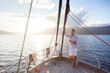 Man traveling on yacht at sea and drinking wine. Sailing trip, summer vacation at sunset. Traveler relaxing, enjoying holidays. Lifestyle moment. Slow living with beautiful view, nature, landscape