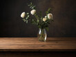 Bouquet of white roses on wooden table against black wall