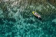 © Soloviova Liudmyla - A lonely female in a straw hat smiling, relaxing lying floating in a kayak on the turquoise Adriatic Sea waves. Aerial coastal top view shot. Exotic countries vacations concept.