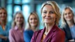 Middleaged businesswoman smiling with team in office tower background. Concept Corporate Team Photoshoot, Businesswoman Smiling, Office Tower Background, Middle-Aged Professionals
