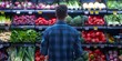 A man shopping for vegetables in a supermarket viewed from behind. Concept Grocery Shopping, Man's Back, Supermarket Scene, Vegetable Aisle, Daily Routine