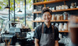 Smiling barista Man at cozy café with warmth and hospitality. Coffee machine and various utensils add to ambiance of coffee shop. Bright and inviting atmosphere for delightful coffee experience	