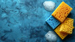 Cleaning Sponges and Soap Suds on Blue Surface