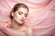 beautiful young woman in pastel pink silk veil. Sensual Girl with make-up
