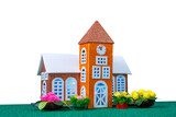 Fototapeta Tęcza - Small orange toy chapel with lights in the windows