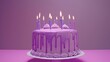 © Wall - A birthday cake with purple icing and lit candles on a purple cake stand against a pink table, backed by a purple background