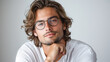 © Julija - portrait of an attractive man with glasses and long hair  in a thinking pose.