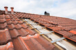 Partially uncovered house roof to replace the old roof tiles