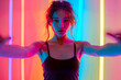 Vibrant Female Dancer Showcasing Modern Choreography with Hypnotic Hand Movements on Colorful Funky Background: A Portrait of Energy and Talent