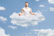 Man in white clothes meditating on a cloud