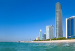 Panoramic view of Abu Dhabi with sea, sand, skyscrapers against blue sky