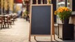 © Марина Терехова - Signboard on the street. Empty menu board stand. Restaurant sidewalk chalkboard sign board. Freestanding A-frame blackboard near flower shop ur cafe. Copyspace for text