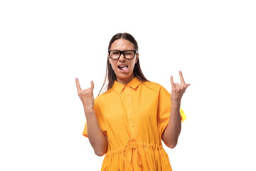 Wall Mural - european young brunette lady dressed in orange summer dress shows cool gesture