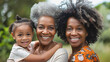 Multi generational african women smiling on camera - Grandmother with grey afro hair, mother and child hugging each other - Mothers day concept