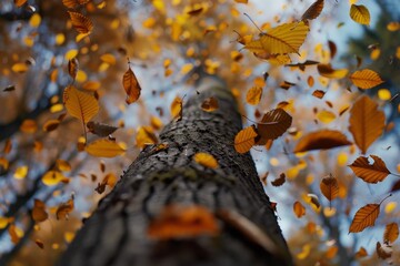 Canvas Print - A tall tree with an abundance of green leaves fluttering in the wind, A dynamic composition of leaves fluttering and cascading down from a tall tree, captured in motion