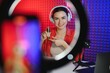 © Serhii - Young creative woman live streaming a video for her followers on social media