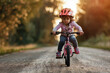Young Girl Learning to Ride Bike on Sunny Country Road