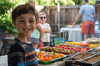 Happy Boy Enjoying a Summer Barbecue Party Outdoors