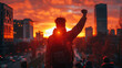 Man Raising Fist Towards Sunset Over City Skyline