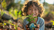 Young Child Delightedly Holds a Sprouting Plant and Earth Model on Earth Day Outdoors