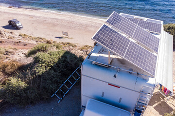 Wall Mural - Caravan with tilt solar panels on roof. Aerial view.