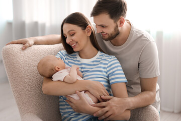 Wall Mural - Happy family. Parents with their cute baby at home