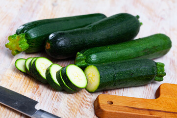 Wall Mural - Fresh organic zucchini sliced on wooden cutting board