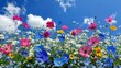 A vibrant and colorful field featuring a diverse variety of flowers under a bright blue sky with fluffy clouds, showcasing nature's vivid palette