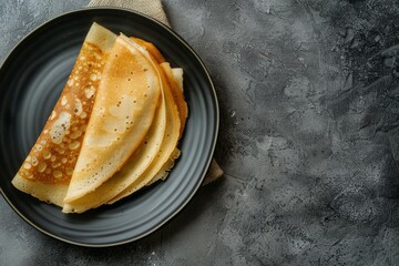 Wall Mural - A plate of pancakes is on a table