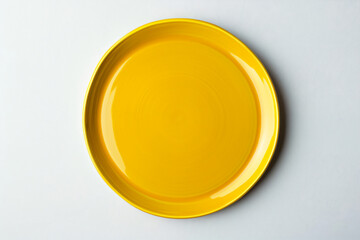 Wall Mural - a yellow plate on a white surface