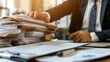 © ISK PRODUCTION - Businessman hands working in Stacks of paper files for searching information on work desk in office
