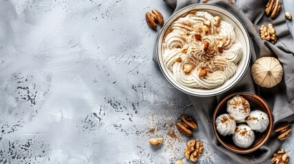 Poster -   A gray backdrop holds a bowl brimming with whipped cream Surrounding it are scattered nuts, while a gray napkin lies nearby A separate bowl of walnuts is