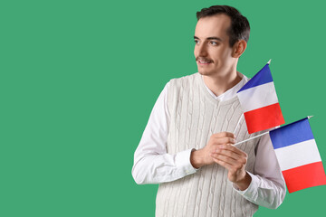 Sticker - Handsome man with flags of France on green background