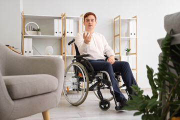 Poster - Young businessman in wheelchair at office