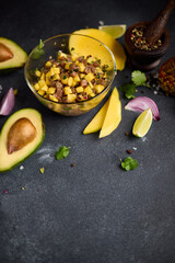 Canvas Print - Cooking traditional tuna and mango tartare - chopped and mixed tuna, mango, cilantro and onion in a glass bowl