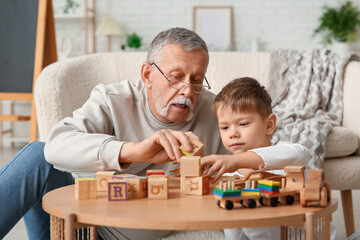 Canvas Print - Grandfather playing with his cute little grandson at home