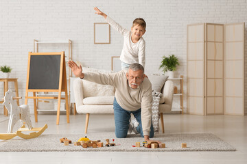 Poster - Grandfather with his cute little grandson having fun together at home