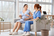© Pixel-Shot - Young pregnant woman talking to doctor in clinic
