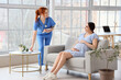 © Pixel-Shot - Young pregnant woman visiting doctor in clinic