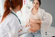 © Pixel-Shot - Young pregnant woman visiting doctor in clinic