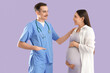 © Pixel-Shot - Young pregnant woman with doctor on lilac background