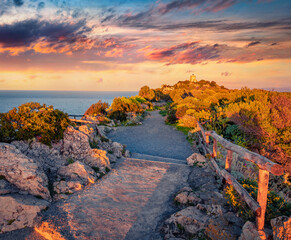 colorful summer scene of Milazzo cape. Great sunrise on nature reserve Piscina di Venere with old lighthouse, Sicily, Italy, Europe. Beauty of nature concept background.