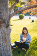 © Strelciuc - Pretty adult woman reading a book literature novel in summer garden park outdoors, dreaming imagining. Education or reading homework