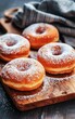 Glazed Doughnuts Sprinkled With Powdered Sugar on a Wooden Board