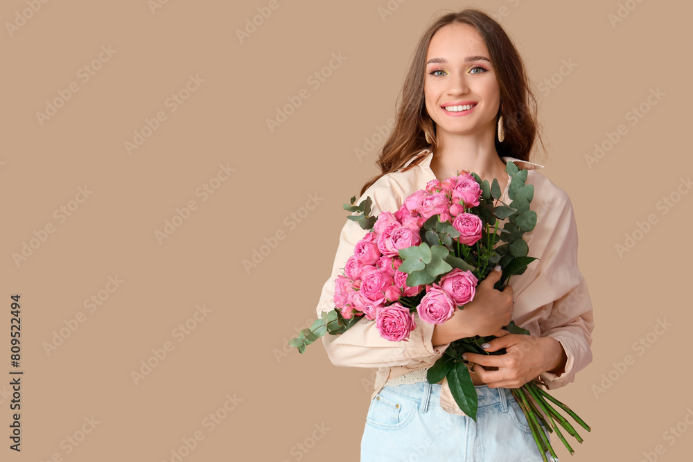 Beautiful young woman with roses on brown background