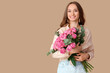 © Pixel-Shot - Beautiful young woman with roses on brown background