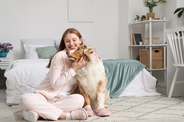 Sticker - Young woman and cute Australian Shepherd dog with slippers at home